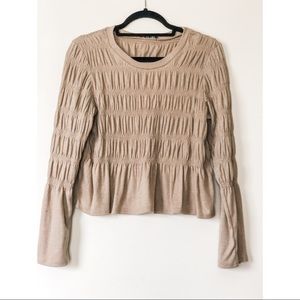 Tan long sleeve shirt with ruched detail.
